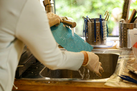 Helen washing freshly dyed dial blanks